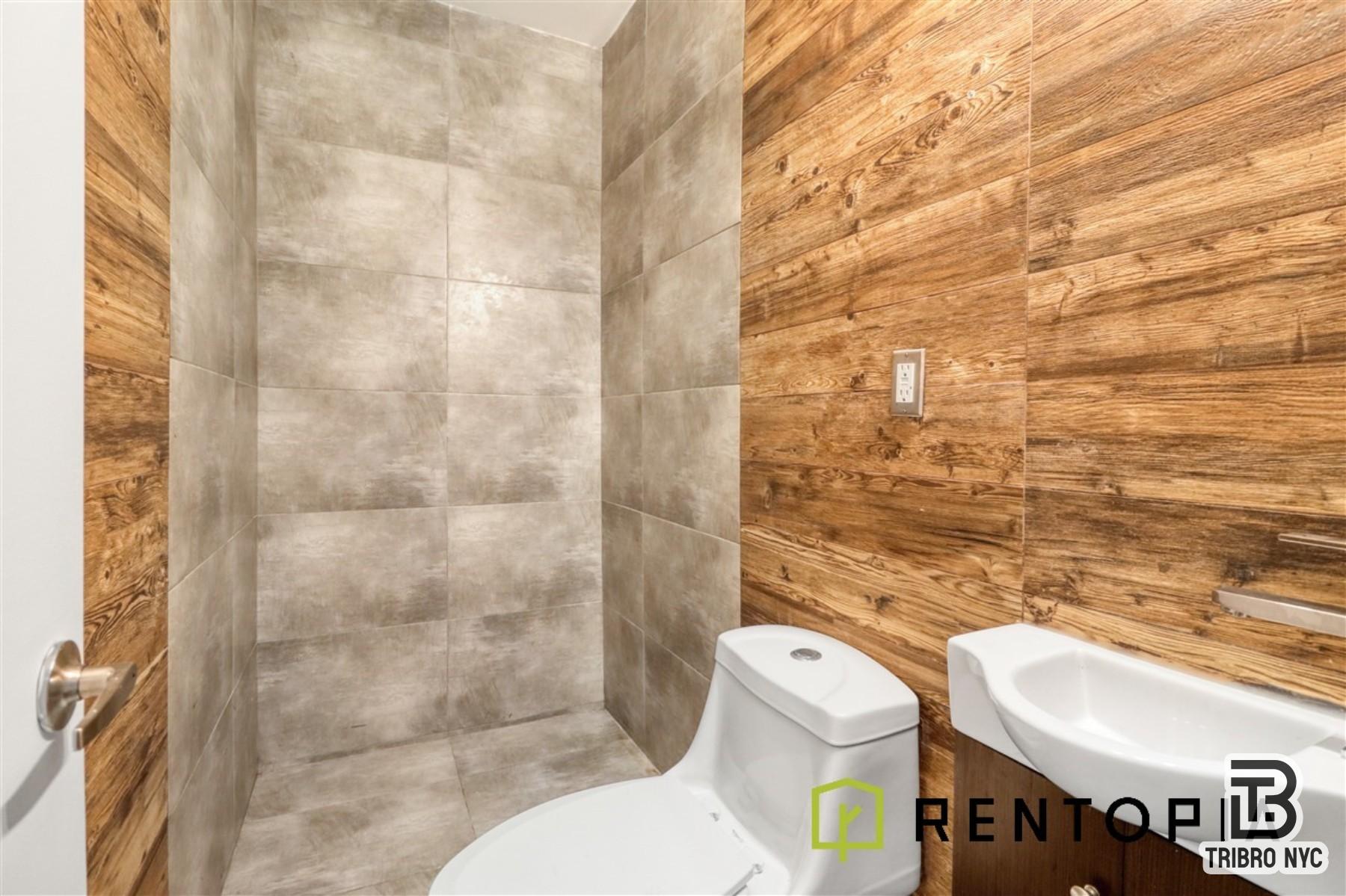 753 Lexington Avenue, Unit 1D Brooklyn, NY 11221 - Photo 8 of 8 a white toilet sitting next to a bathroom sink