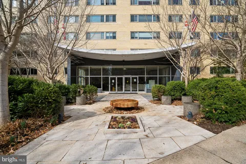 a front view of a building with a yard