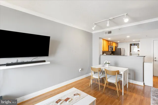 a view of a dining room with furniture and wooden floor