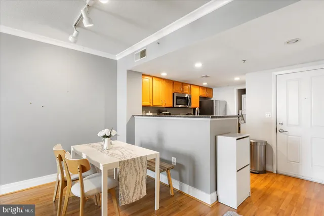 a view of a dining room with furniture and wooden floor