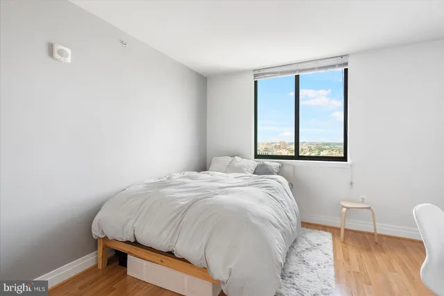 a bedroom with a bed and a chair