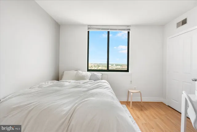 a bedroom with a bed and a window