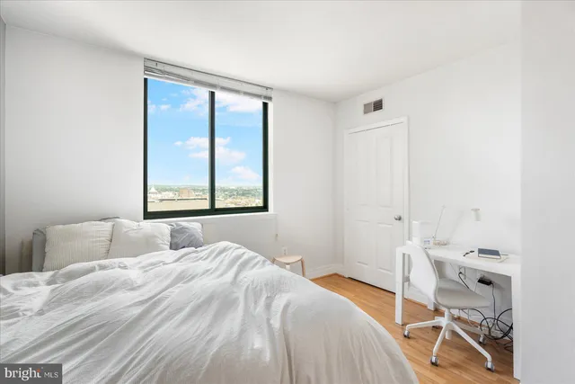 a bedroom with a bed and a window