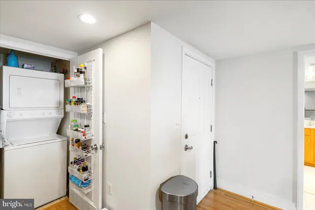 a room with a refrigerator and a wooden floor
