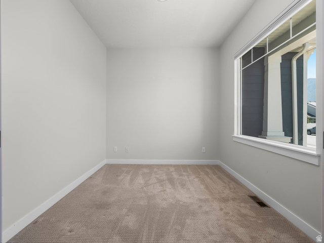 2786 West Hancock Street, Unit 198 Mapleton, UT 84664 - Photo 18 of 33 Carpeted room featuring a large window, neutral wall paint, and white trim