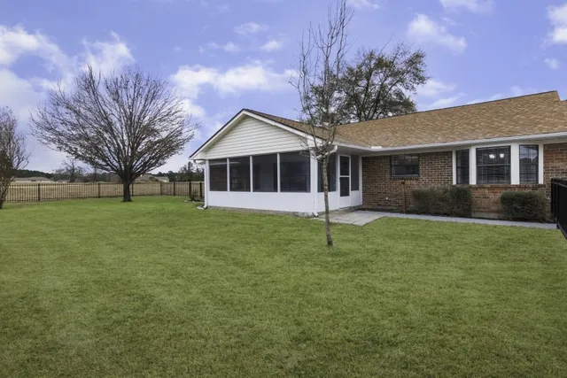 a house that has a tree in front of it