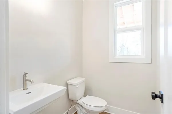 a white toilet sitting next to a bathroom sink