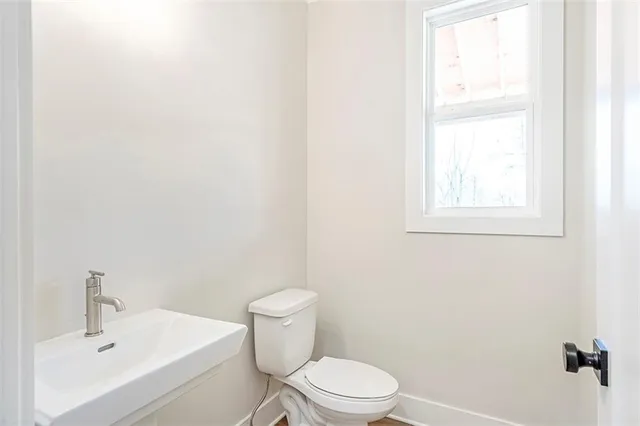 a white toilet sitting next to a bathroom sink