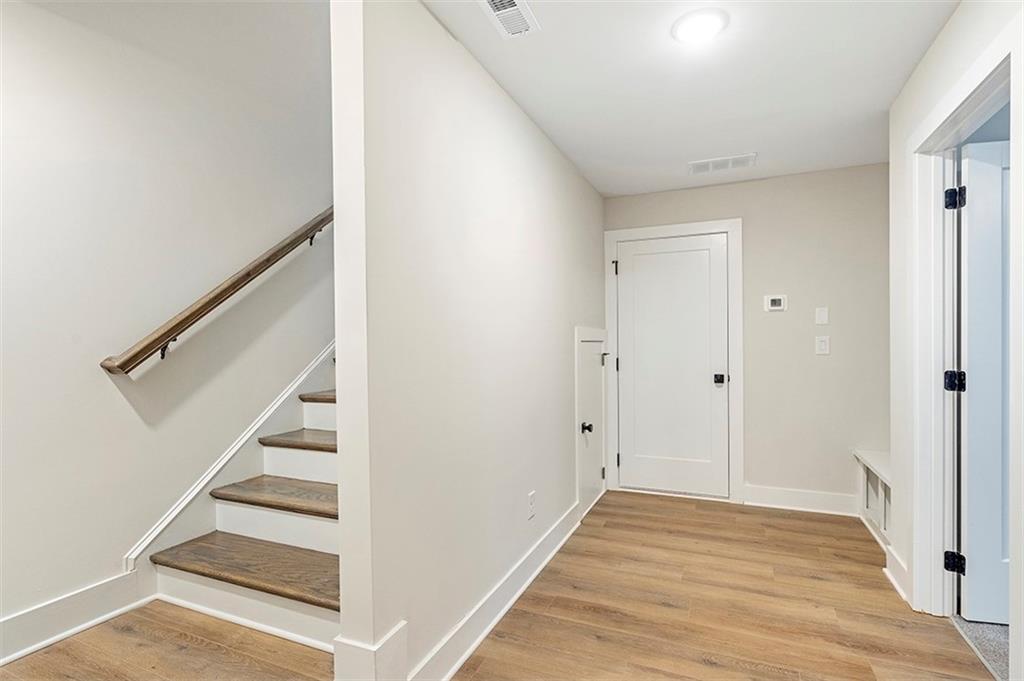 152 Palm Street Holly Springs, GA 30115 - Photo 20 of 33 a view of a hallway with wooden floor and entryway