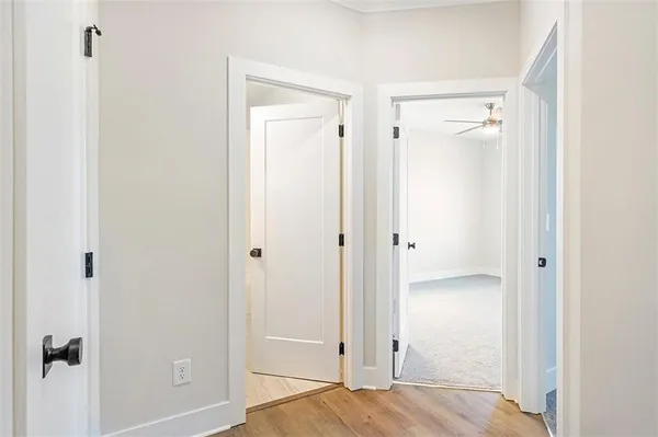 a view of a bedroom with wooden floor