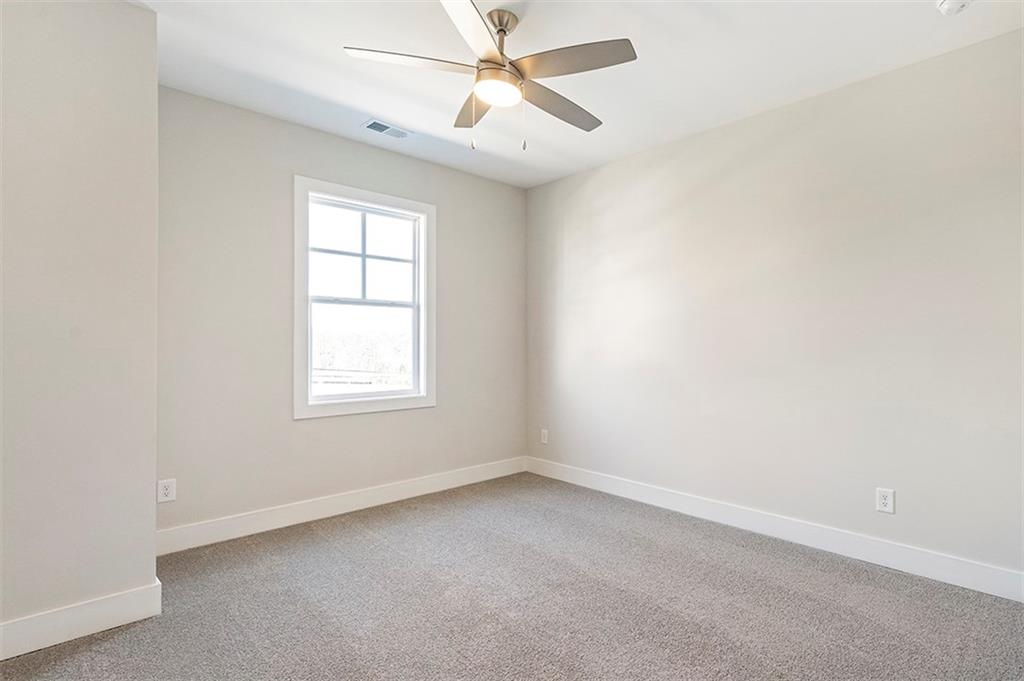 152 Palm Street Holly Springs, GA 30115 - Photo 25 of 33 an empty room with a window and a fan