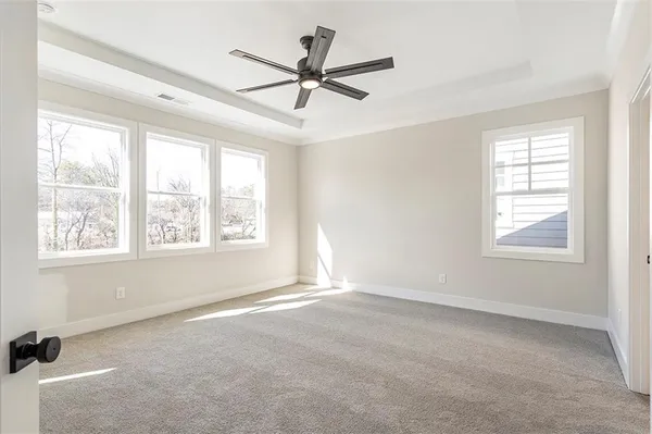 a view of a livingroom with a ceiling fan and window