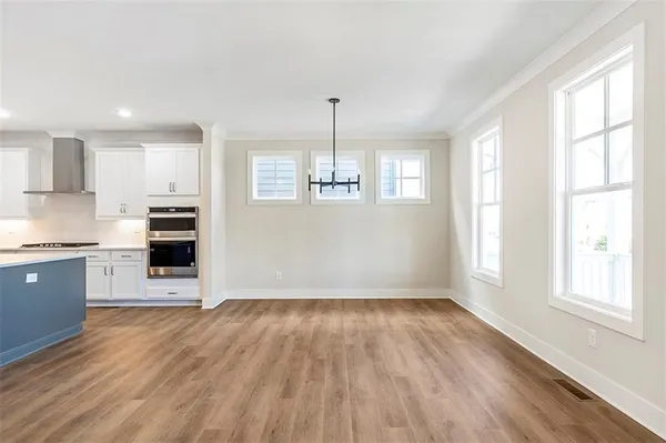 a kitchen with granite countertop a stove and wooden floor
