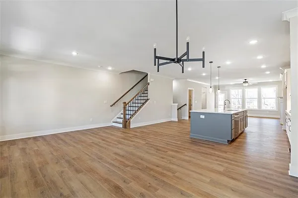 a view of kitchen and kitchen with sink wooden floor