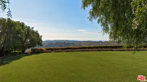 a view of a lake with houses in the back