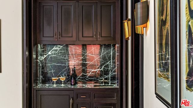 a view of water heater and wooden cabinets