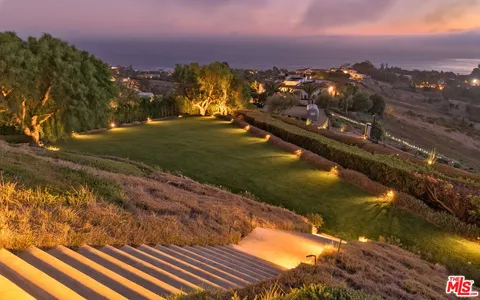 a view of swimming pool with a table and chairs in a yard