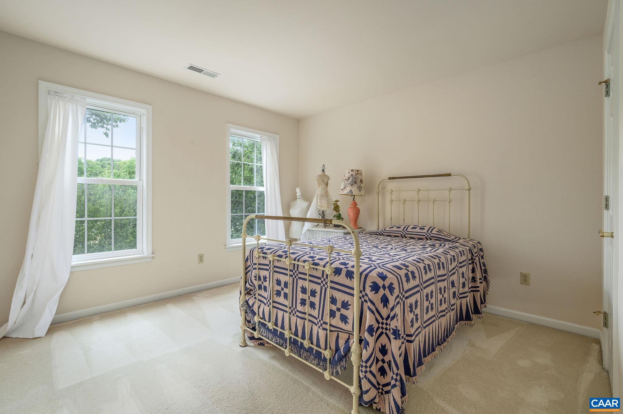 1330 Mosby Rch Charlottesville, VA 22901 - Photo 13 of 25 a bed sitting in a bedroom next to a window