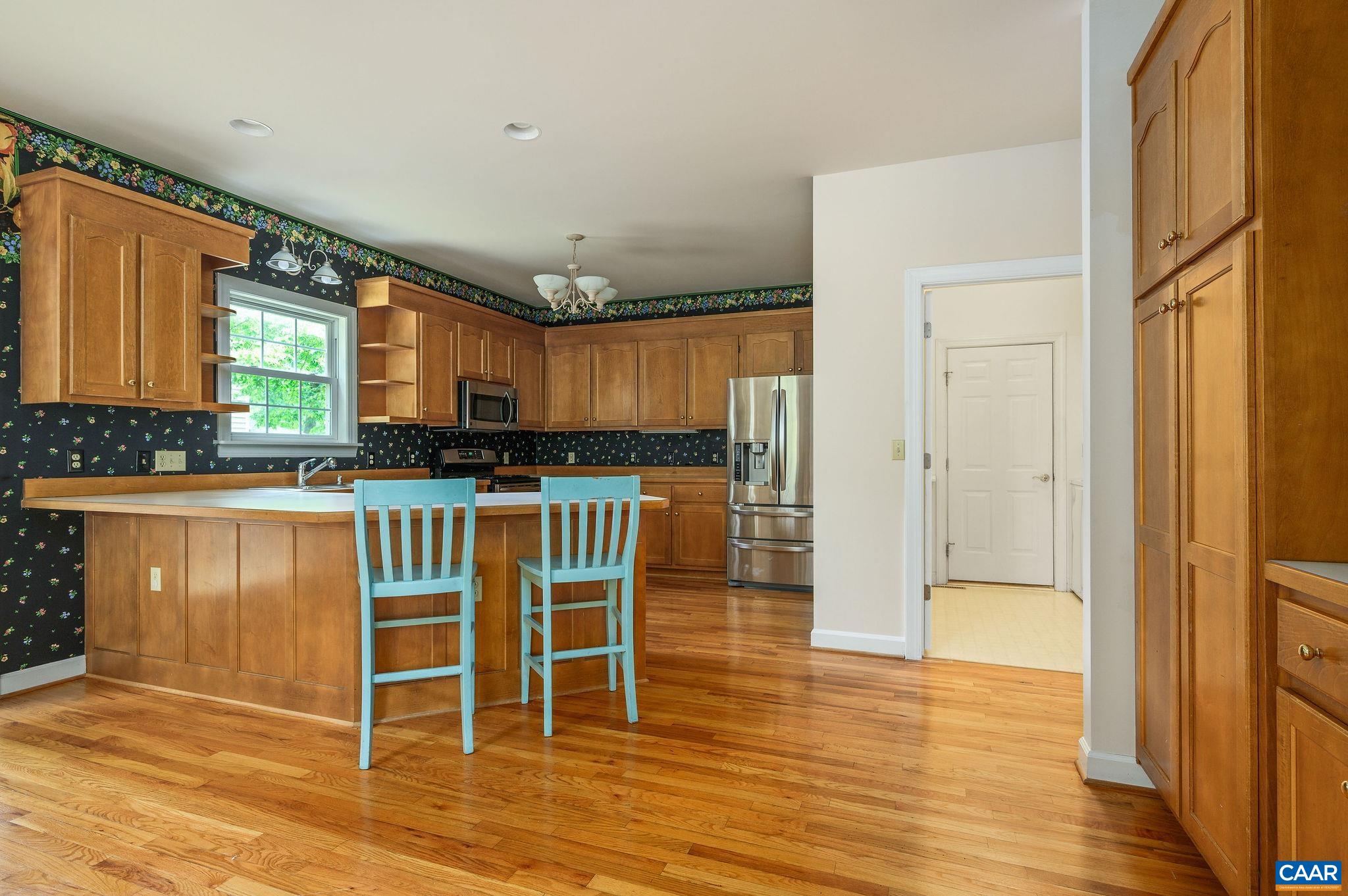 1330 Mosby Rch Charlottesville, VA 22901 - Photo 6 of 25 a kitchen with granite countertop a refrigerator and wooden cabinets