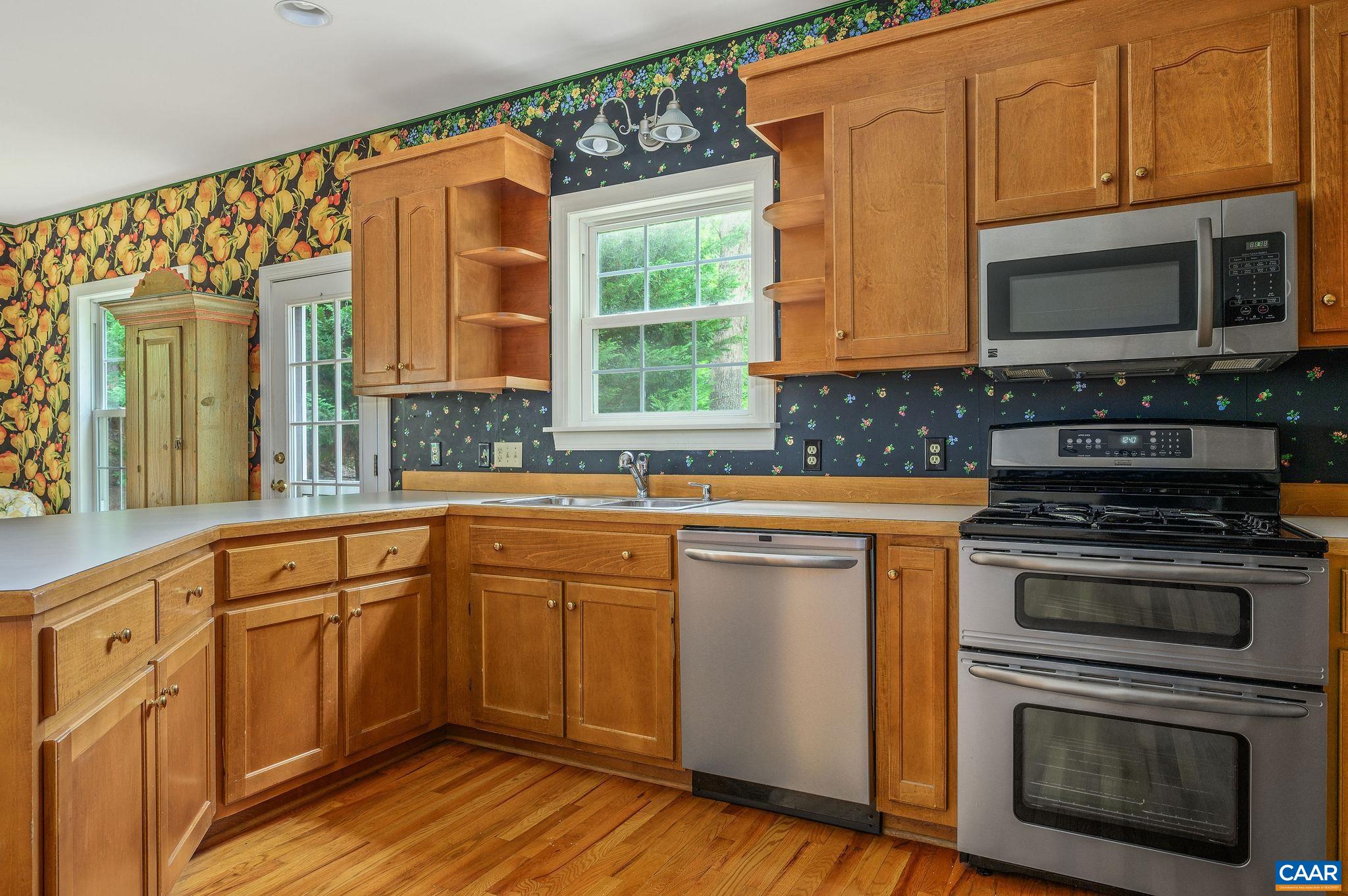 1330 Mosby Rch Charlottesville, VA 22901 - Photo 9 of 25 a kitchen with stainless steel appliances granite countertop a stove a sink and a microwave