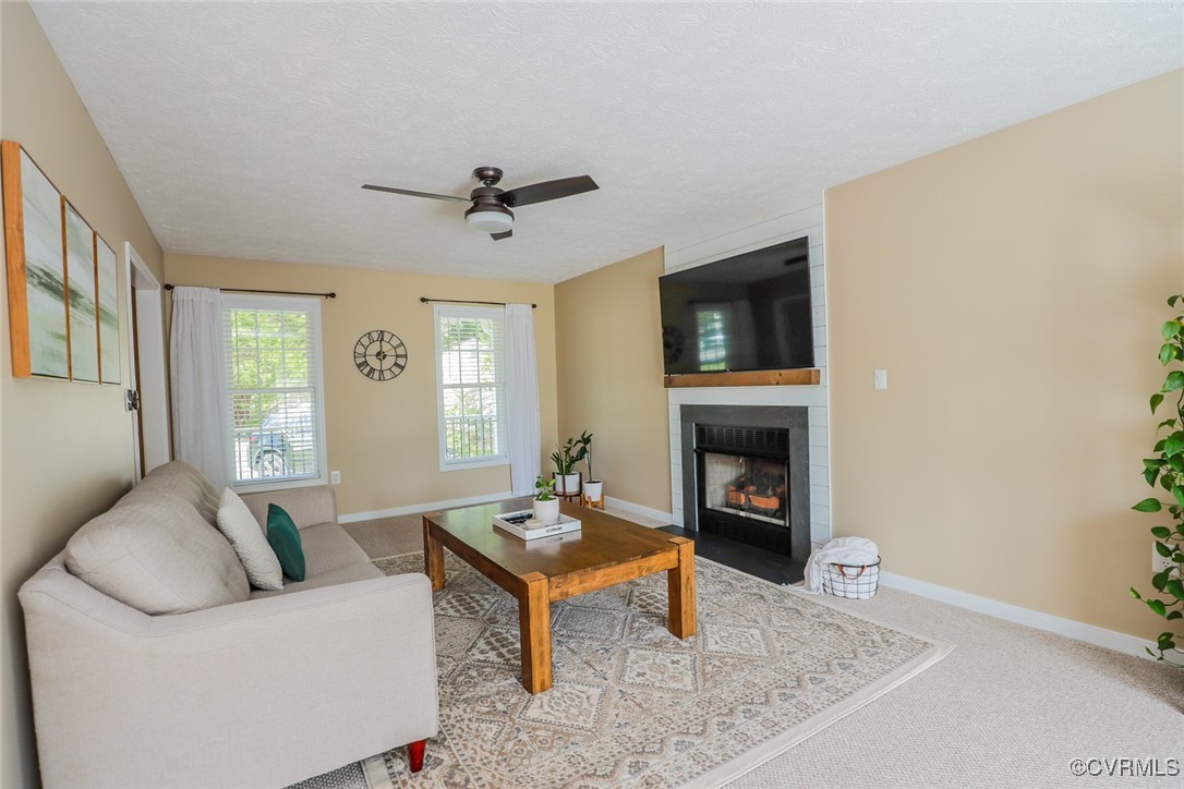 11400 Bailey Mountain Trail Midlothian, VA 23112 - Photo 13 of 41 a living room with furniture a fireplace and a flat screen tv