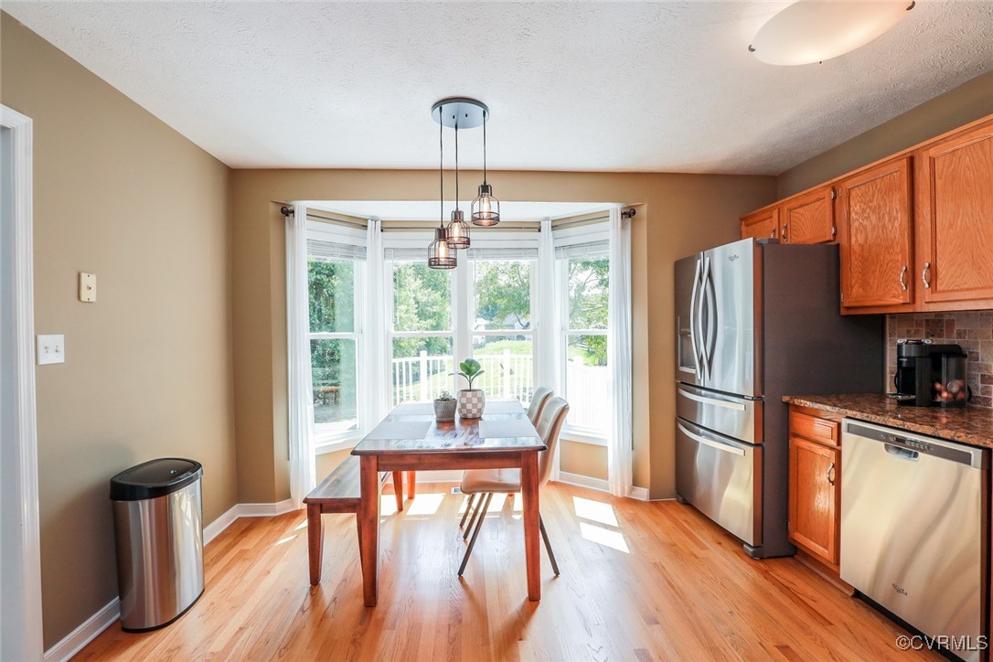 11400 Bailey Mountain Trail Midlothian, VA 23112 - Photo 24 of 41 a dining room with furniture a chandelier and wooden floor