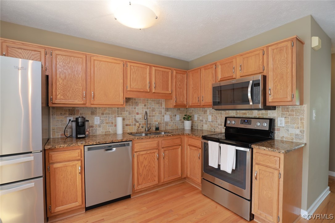 11400 Bailey Mountain Trail Midlothian, VA 23112 - Photo 26 of 41 a kitchen with a sink microwave and refrigerator