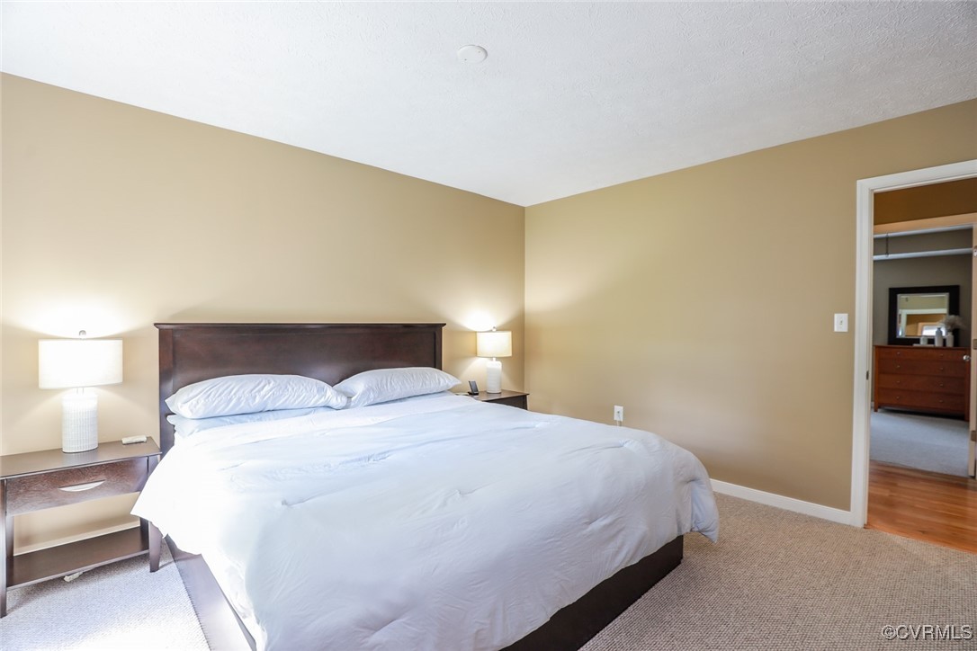 11400 Bailey Mountain Trail Midlothian, VA 23112 - Photo 30 of 41 a bedroom with a bed and lamps