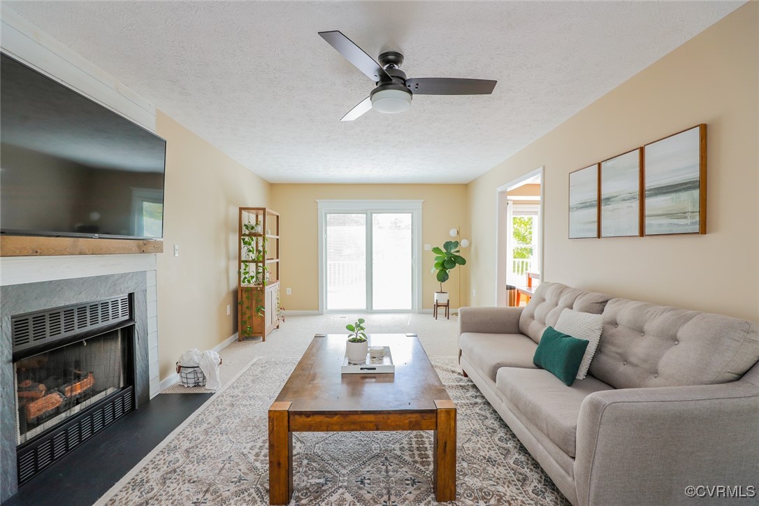 11400 Bailey Mountain Trail Midlothian, VA 23112 - Photo 9 of 41 a living room with furniture a fireplace and a flat screen tv