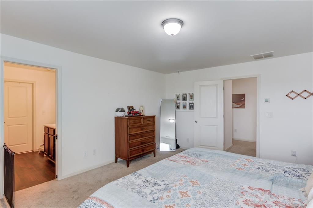 331 Merigold Way Pendergrass, GA 30567 - Photo 17 of 39 a bedroom with a bed and a dresser