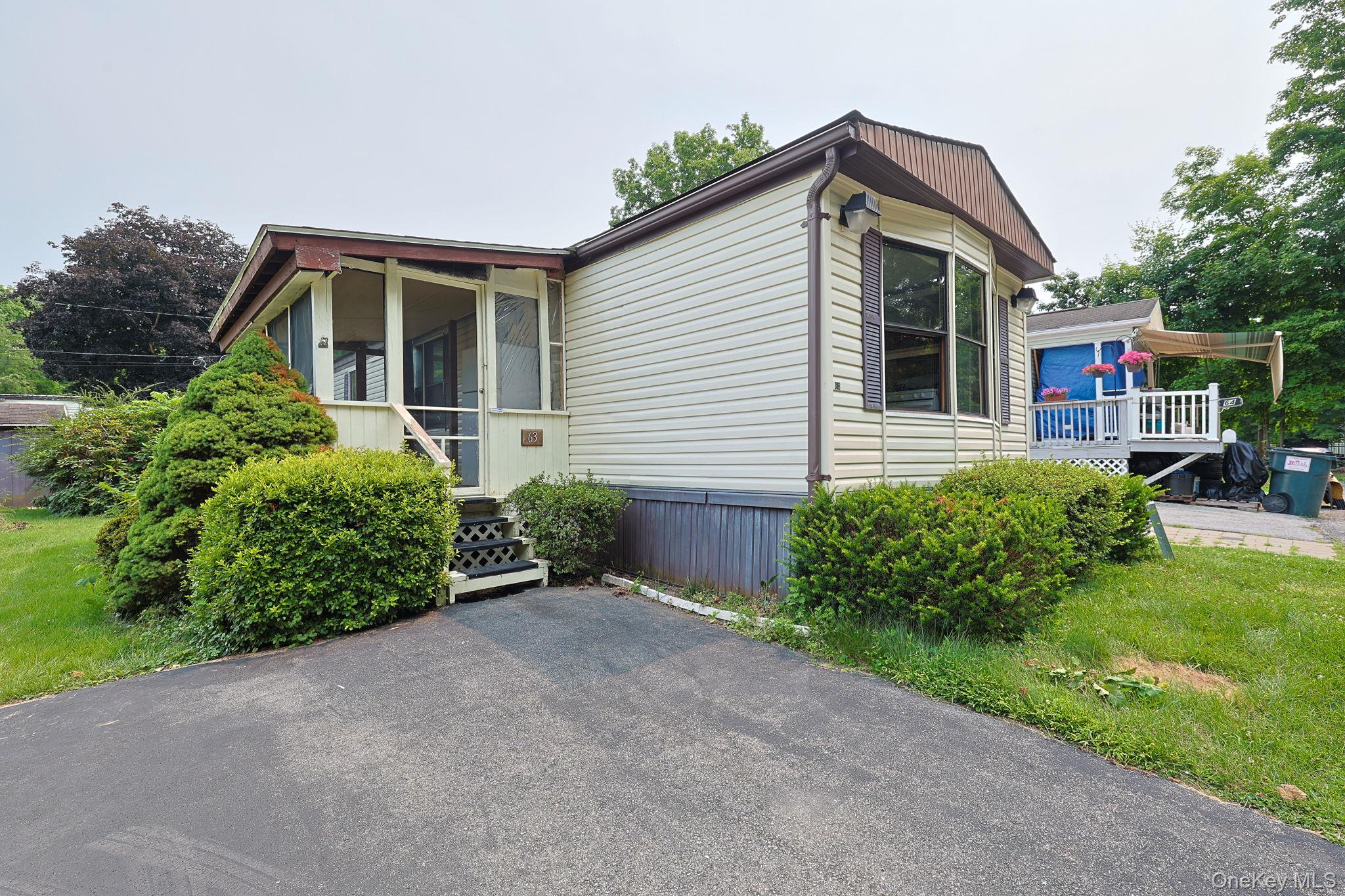 63 Tanglewood Road Hopewell Junction, NY 12533 - Photo 1 of 20 a front view of a house with a yard and potted plants