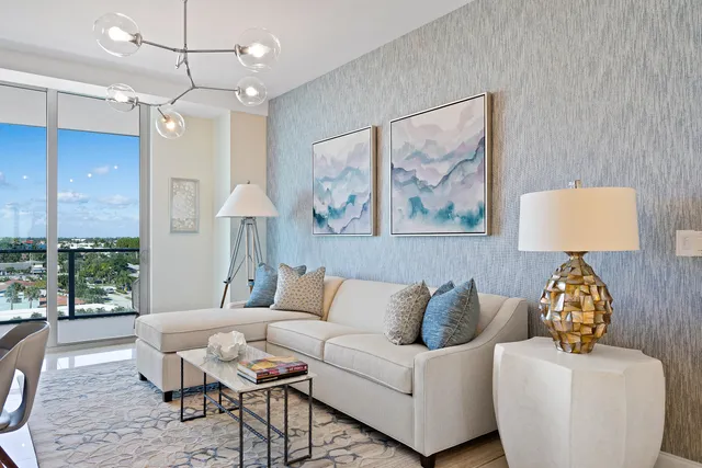 a living room with furniture a chandelier and a painting on the wall