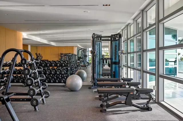 a view of a workspace with furniture and floor to ceiling window
