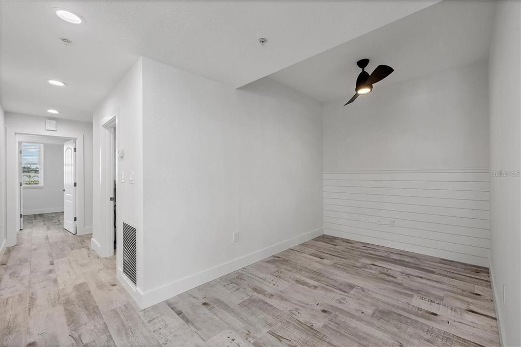9203 Griggs Road, Unit 204 Englewood, FL 34224 - Photo 11 of 32 a view of a room with wooden floor and bathroom