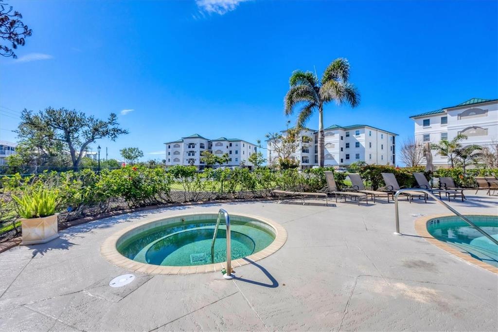 9203 Griggs Road, Unit 204 Englewood, FL 34224 - Photo 29 of 32 a view of a swimming pool with a patio and plants