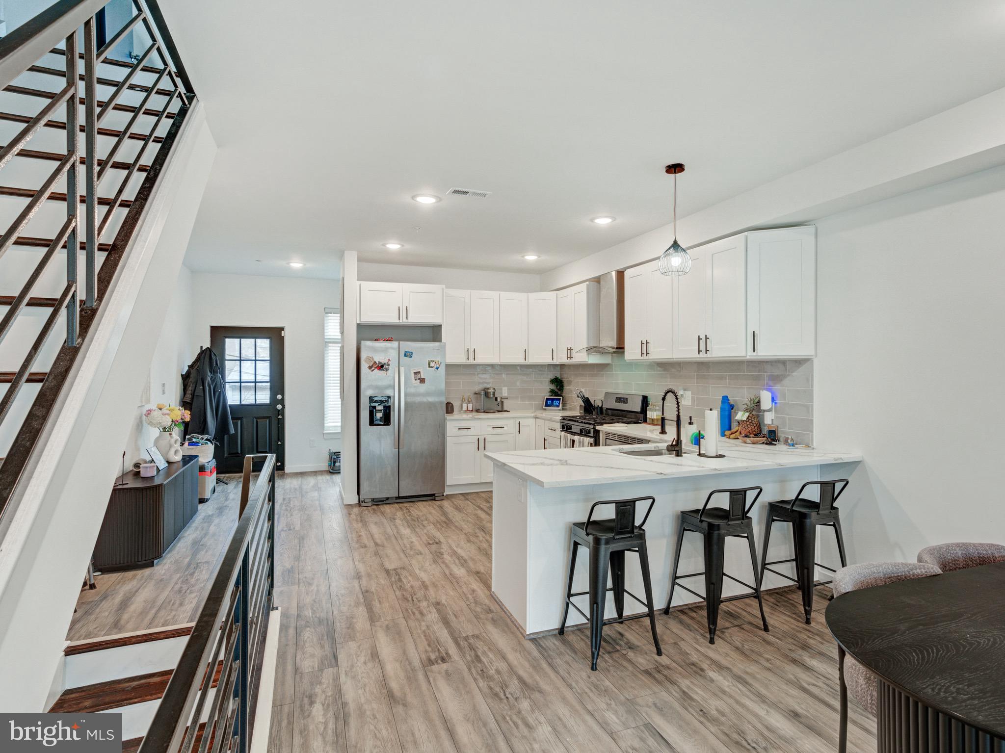 1931 Colonial Street Philadelphia, PA 19138 - Photo 5 of 38 a kitchen with stainless steel appliances a dining table chairs stove refrigerator and cabinets