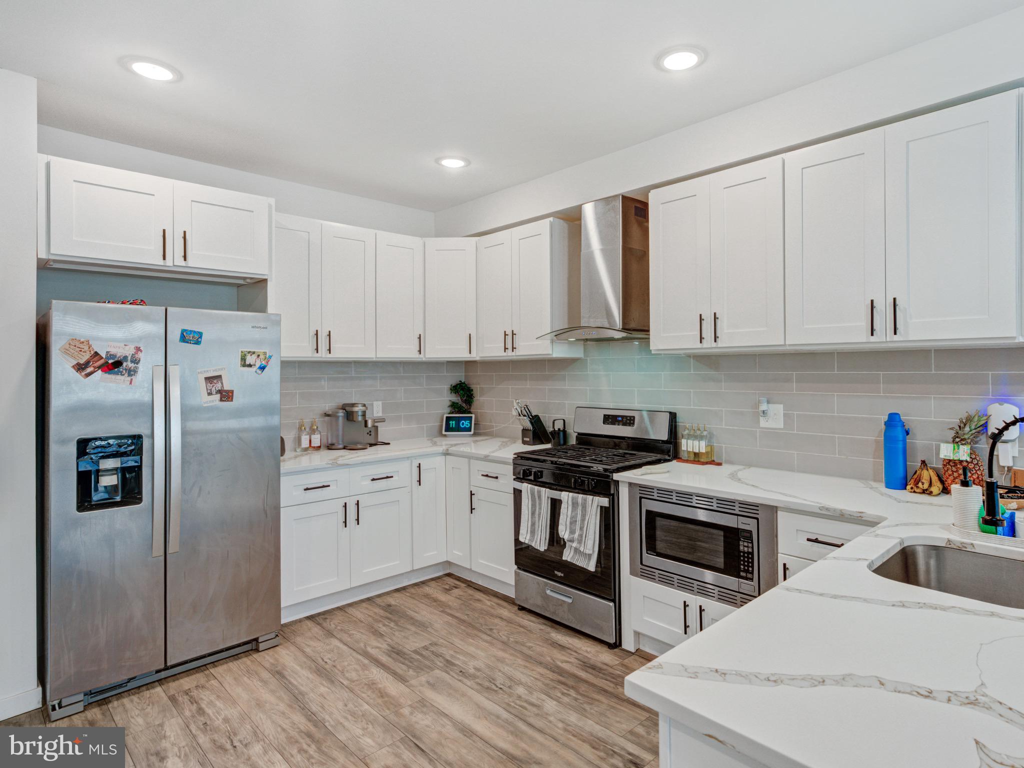 1931 Colonial Street Philadelphia, PA 19138 - Photo 7 of 38 a kitchen with stainless steel appliances granite countertop a refrigerator sink and white cabinets