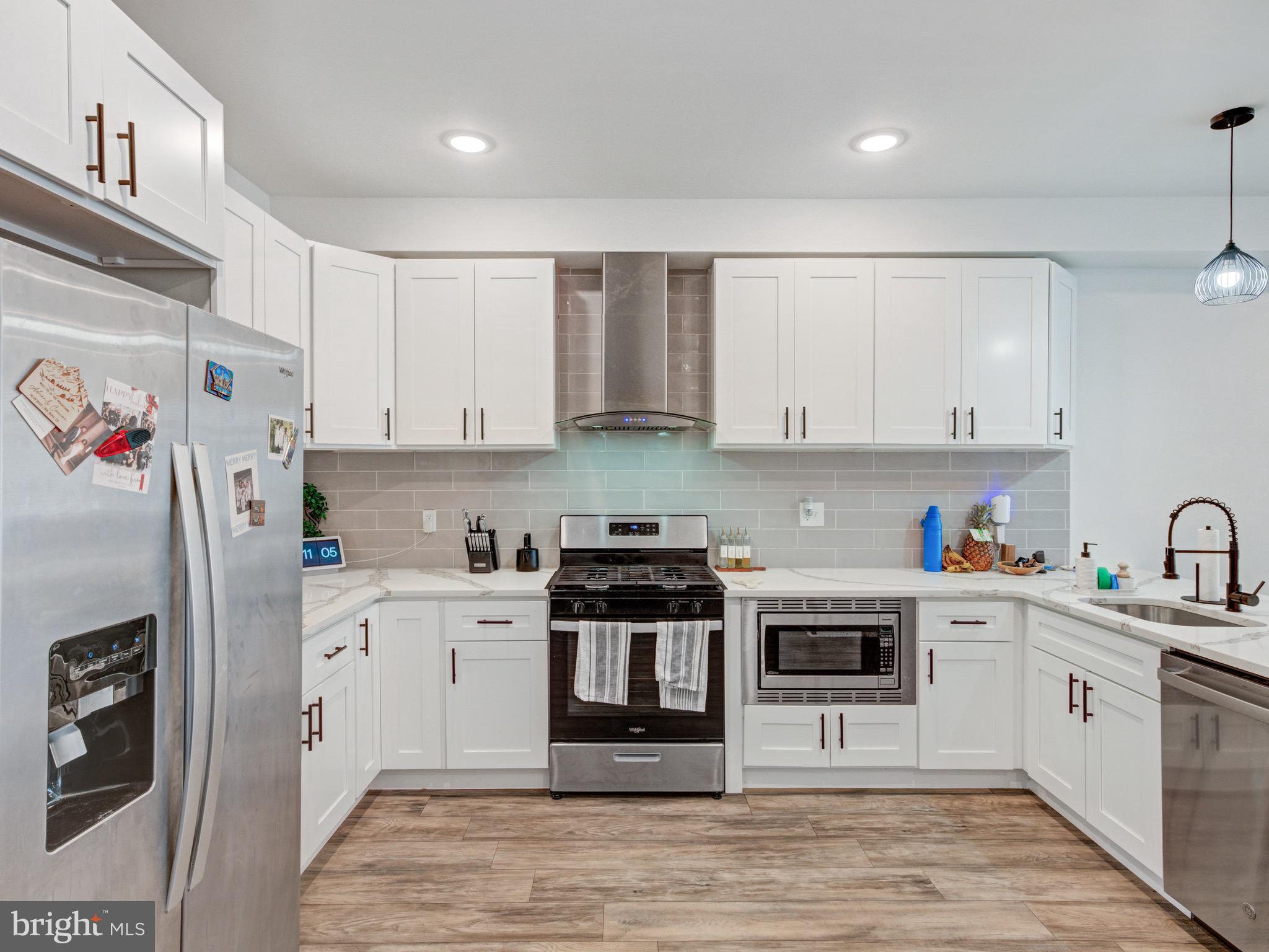 1931 Colonial Street Philadelphia, PA 19138 - Photo 8 of 38 a kitchen with stainless steel appliances granite countertop a refrigerator sink and white cabinets