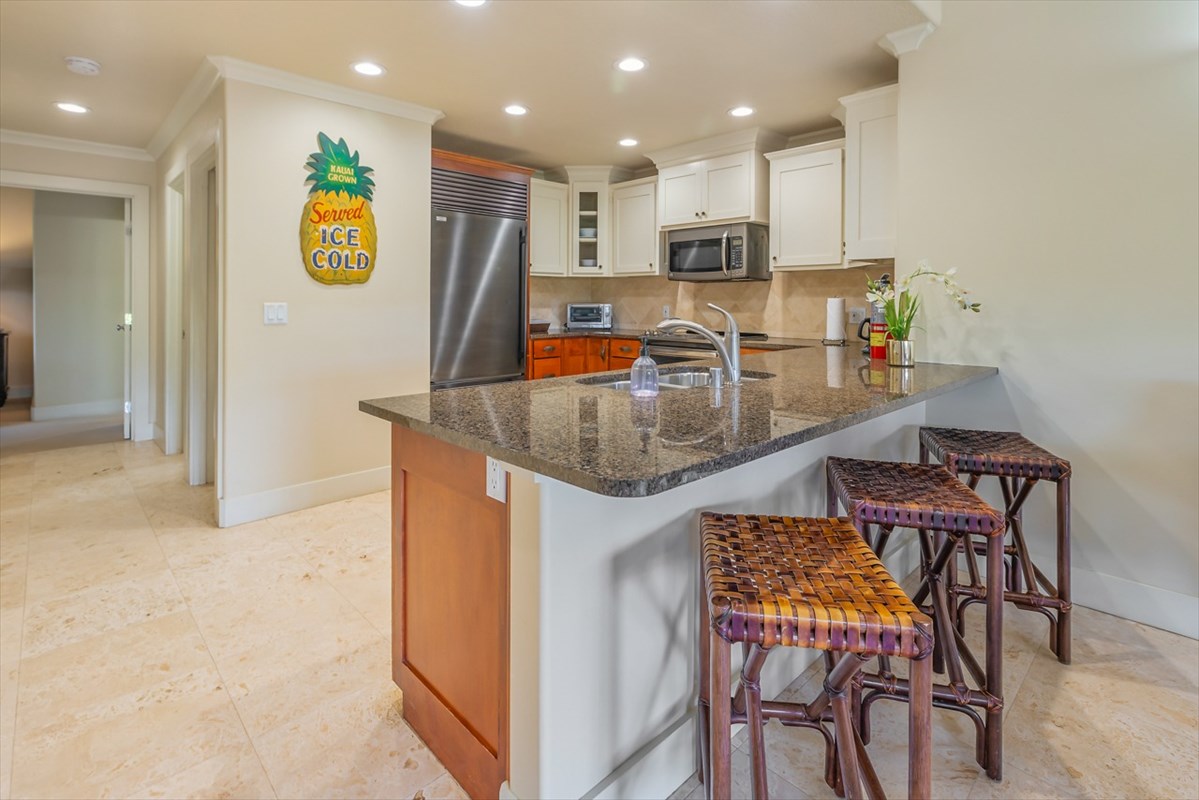 2387 Ho'ohu Road, Unit 221 Koloa, HI 96756 - Photo 13 of 25 a kitchen with stainless steel appliances granite countertop a sink and a refrigerator