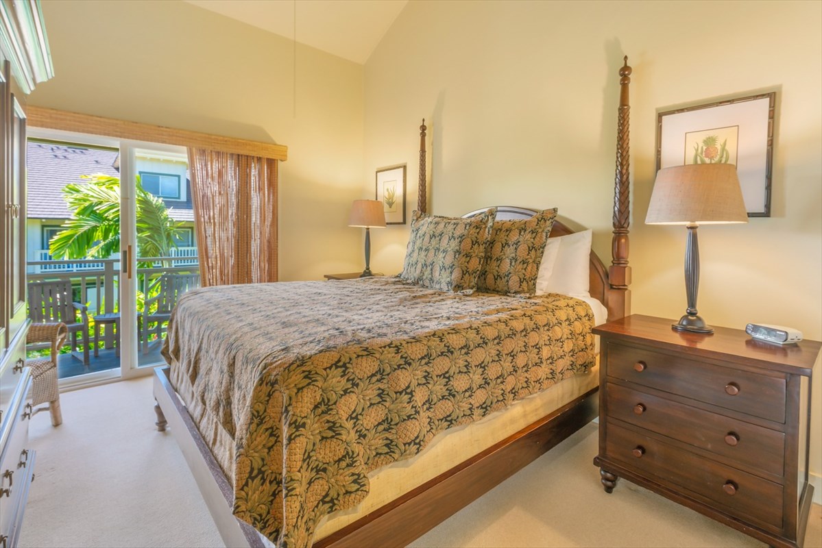 2387 Ho'ohu Road, Unit 221 Koloa, HI 96756 - Photo 14 of 25 a large bed sitting in a bedroom next to a window