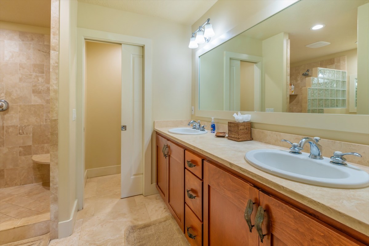 2387 Ho'ohu Road, Unit 221 Koloa, HI 96756 - Photo 16 of 25 a bathroom with a granite countertop sink a mirror and a shower