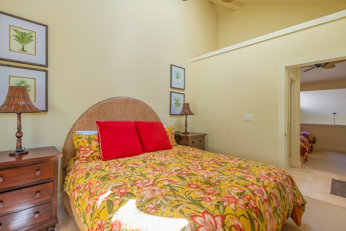 2387 Ho'ohu Road, Unit 221 Koloa, HI 96756 - Photo 23 of 25 a bed sitting in a bedroom and a lamp on dresser