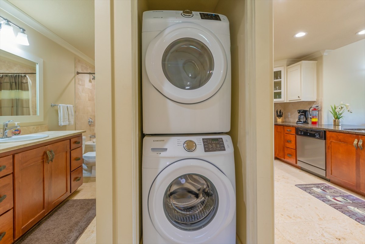 2387 Ho'ohu Road, Unit 221 Koloa, HI 96756 - Photo 24 of 25 a view of a kitchen with stainless steel appliances granite countertop a sink and a washer dryer