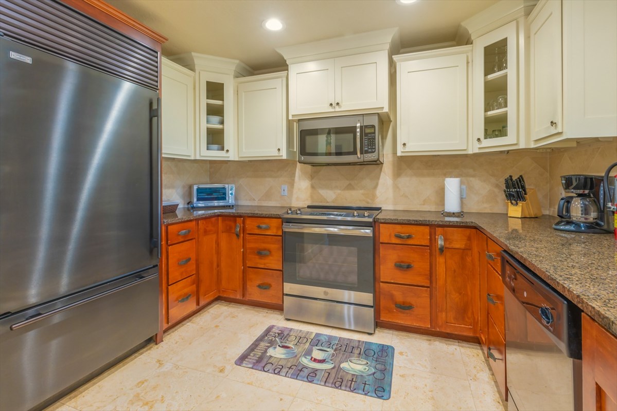 2387 Ho'ohu Road, Unit 221 Koloa, HI 96756 - Photo 4 of 25 a kitchen with stainless steel appliances granite countertop a refrigerator sink and stove