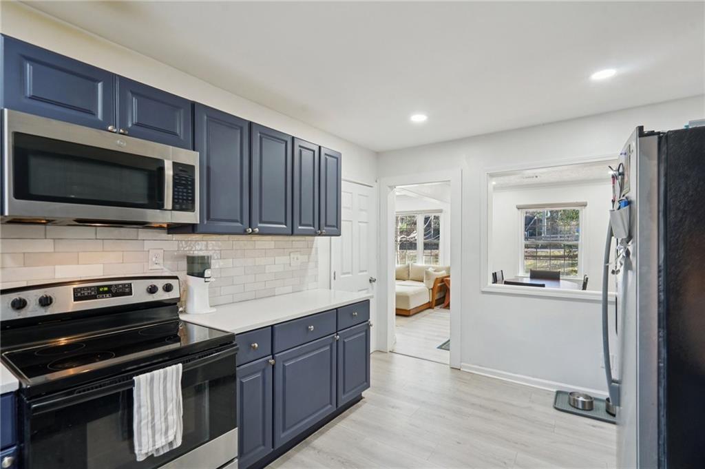 1145 Fayetteville Road Southeast Atlanta, GA 30316 - Photo 15 of 24 a kitchen with stainless steel appliances a stove microwave and sink