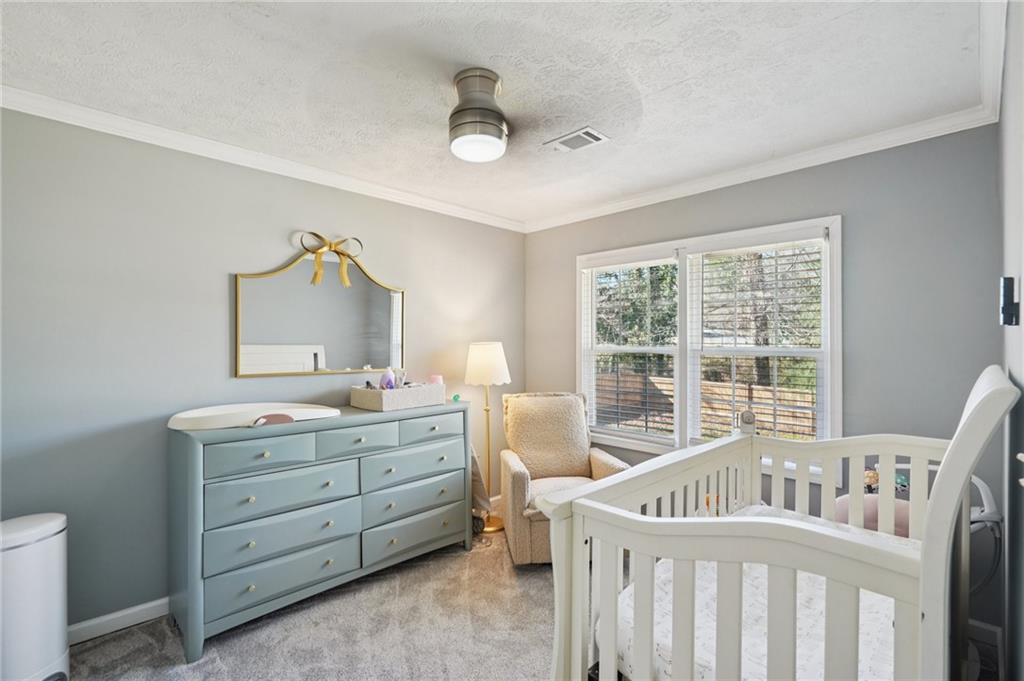 1145 Fayetteville Road Southeast Atlanta, GA 30316 - Photo 16 of 24 a bedroom with a bed and a window