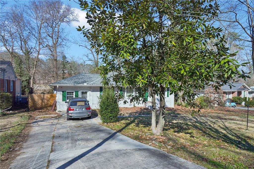 1145 Fayetteville Road Southeast Atlanta, GA 30316 - Photo 2 of 24 a front view of a house with a garden