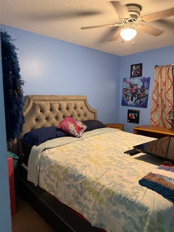 9320 Southeast Maricamp Road Ocala, FL 34472 - Photo 2 of 5 a bedroom with a bed and a chandelier