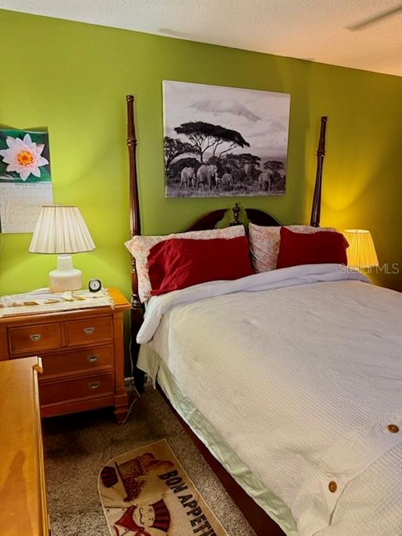 9320 Southeast Maricamp Road Ocala, FL 34472 - Photo 3 of 5 a bedroom with a bed and a painting on the wall