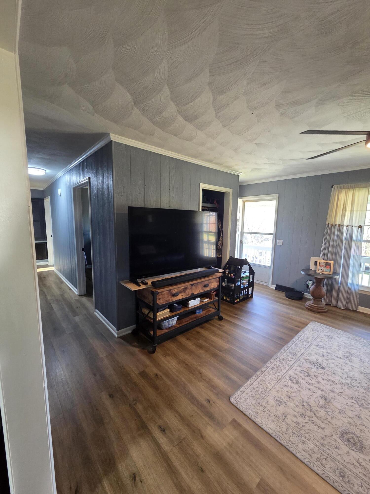 3266 Doe Run Road Rocky Mount, VA 24151 - Photo 3 of 8 a living room with furniture and a flat screen tv
